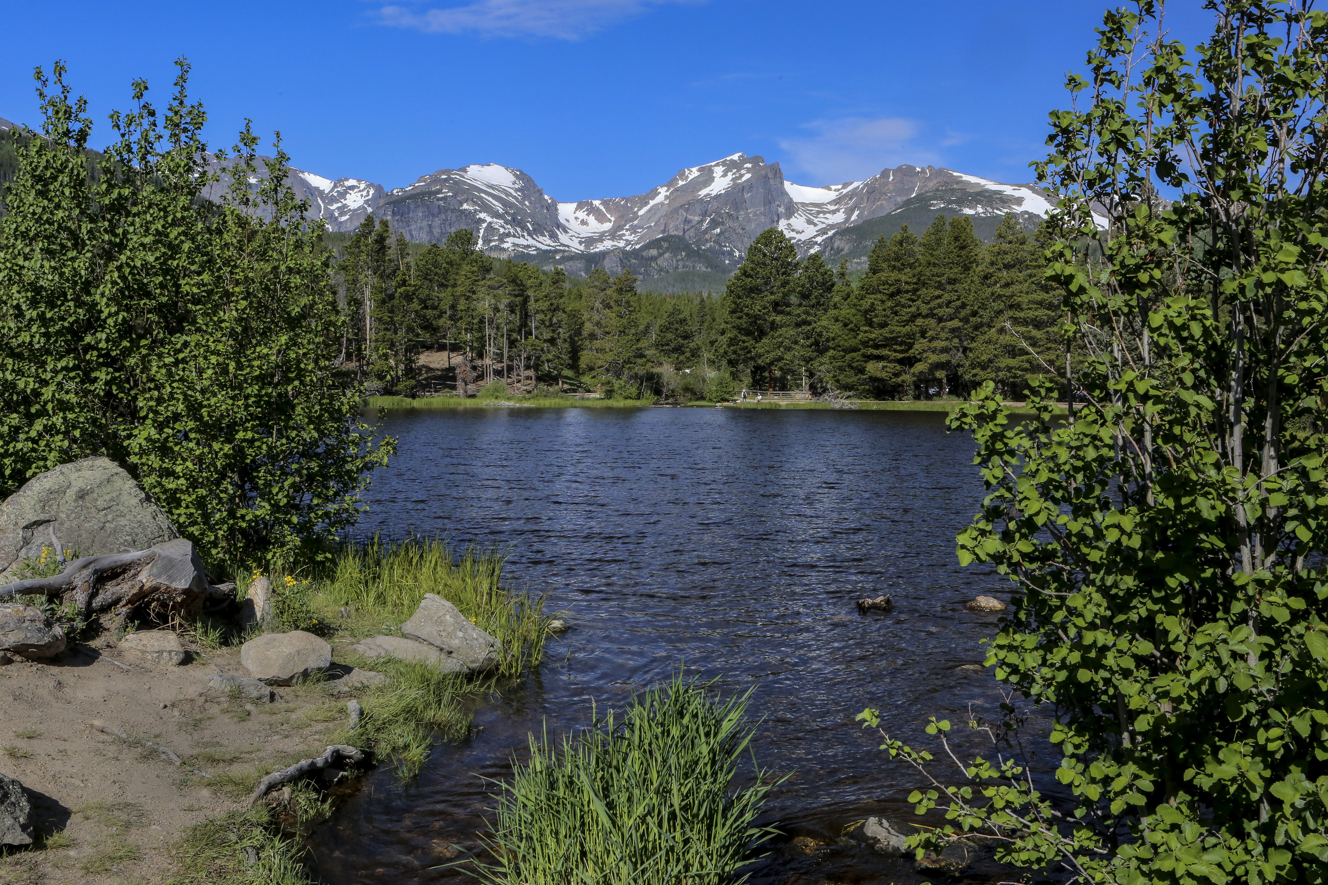 A mountain lake with mountains in the background.