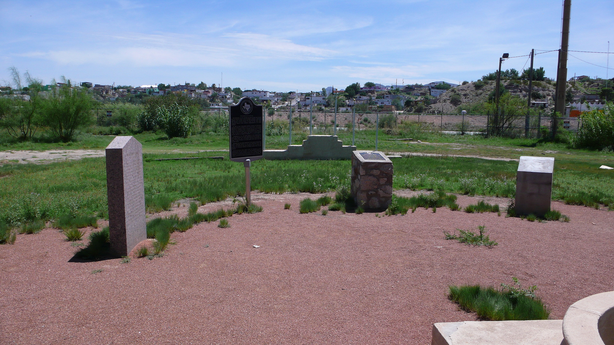 A group of gravestones in a grassy area.