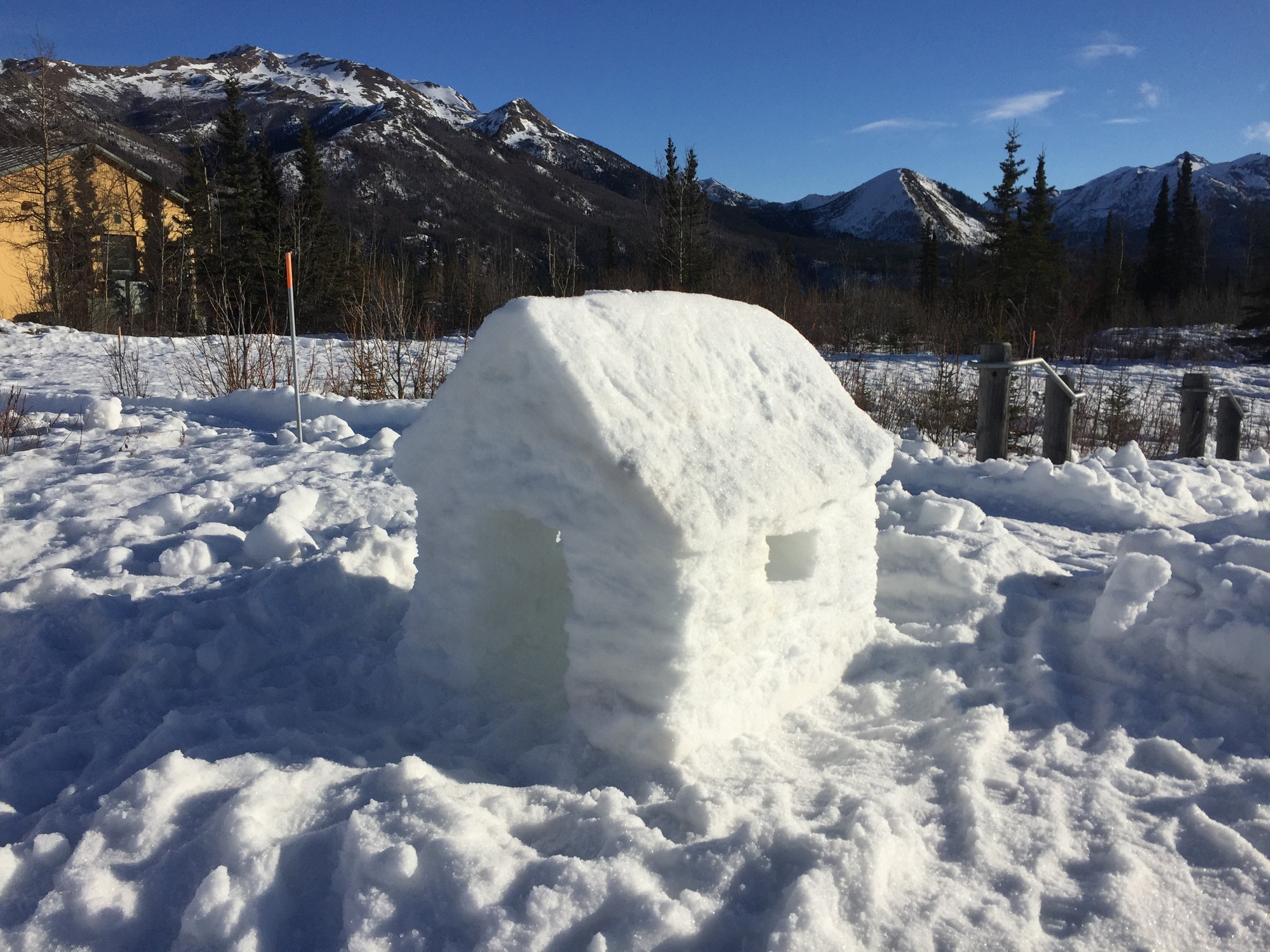 a snow sculpture of a log cabin