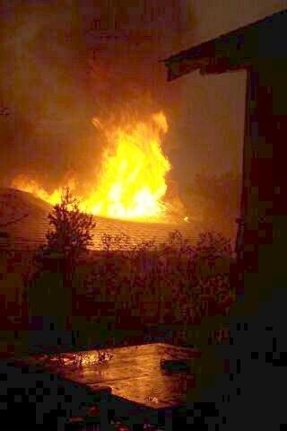 Night photos of a house burning during the Long Mesa fire in Mesa Verde National Park, July-August 2002