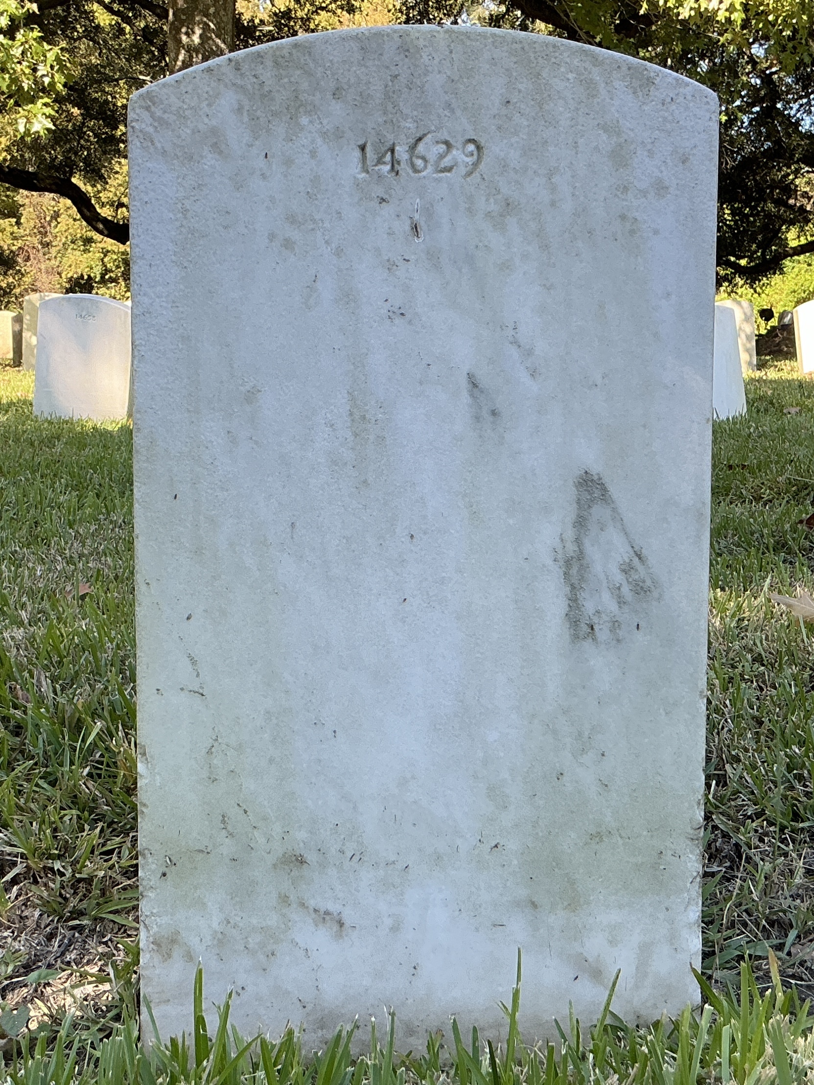 Back of upright marble headstone with flat face.