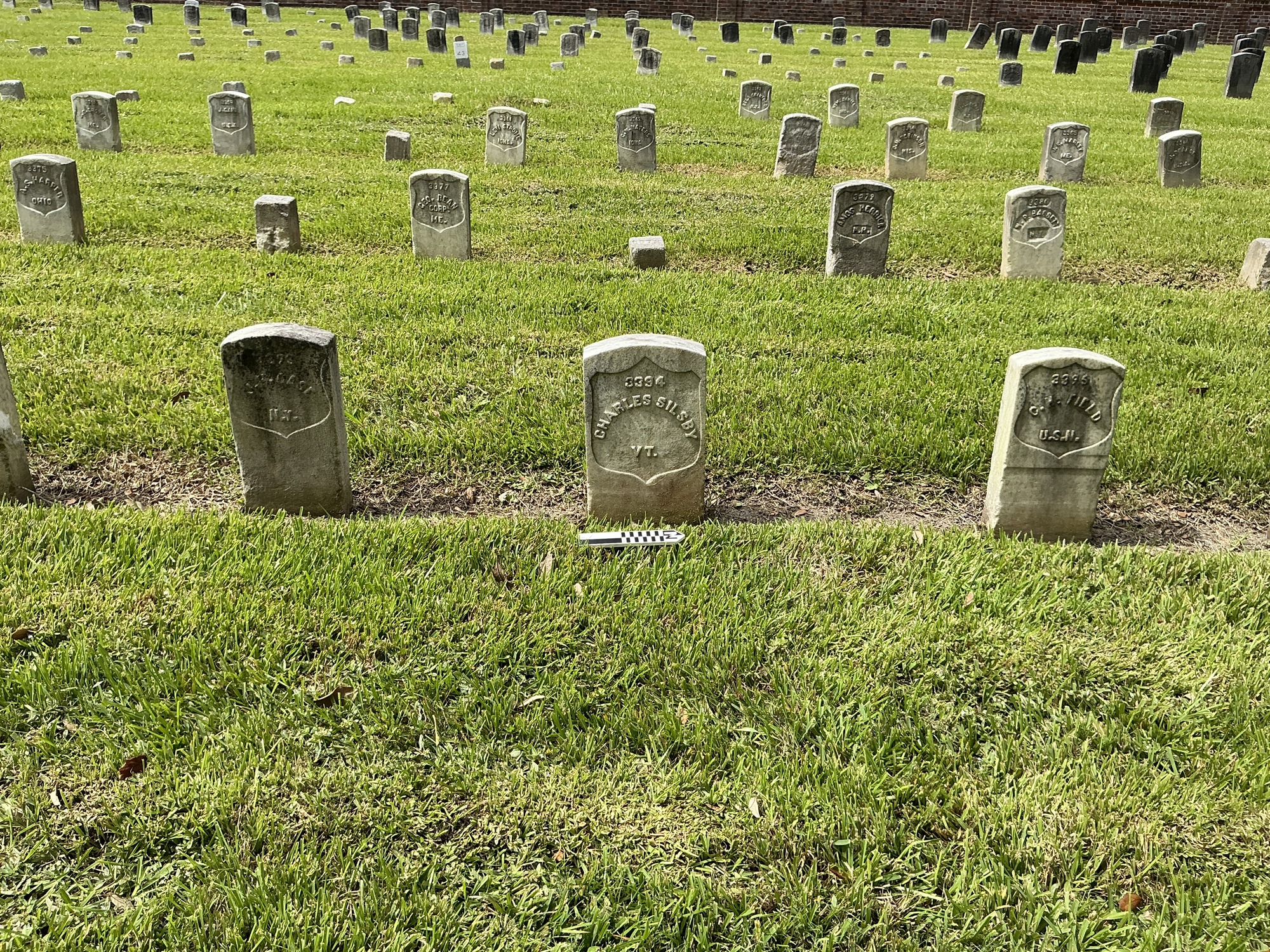 Extra image of historic upright marble headstone with recessed shield face.