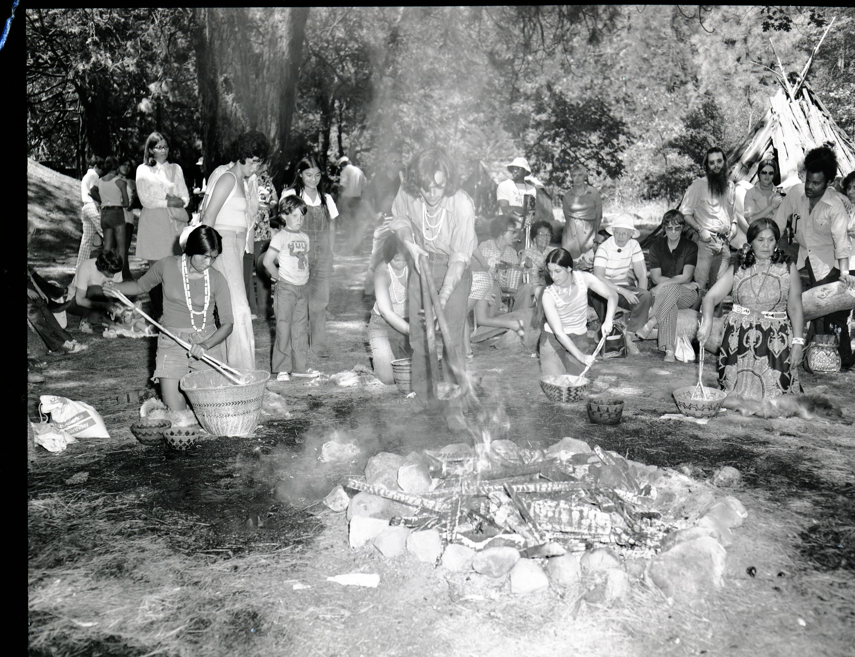 Cooking acorn mush at the Roundhouse dedication, Yosemite Valley. Cooking mush L to R: Lucy Parker, Kim Stevenot, Gael Amend, Bernie Hopper. Craig Bates lifting hot stones from fire.