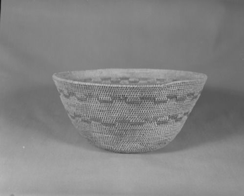Private Collection. Object: Miwok basket. Dimensions: 11 x 5 1/4". Materials: Bracken fern root, split maple shoots (?). Technology: Single rod, interlocking stitch, rim finish by one additional row stitching clockspring start plugged with cloth knot. Inside blackened from use as cooking vessel. Collection History: Purchased from Maggie Longfellow's mother, also known as Mrs. Longfellow Poncho. Photographed by Michael Dixon. Catalogued by Craig Bates and Barbara Beroza. Yosemite Collections, National Park Service.