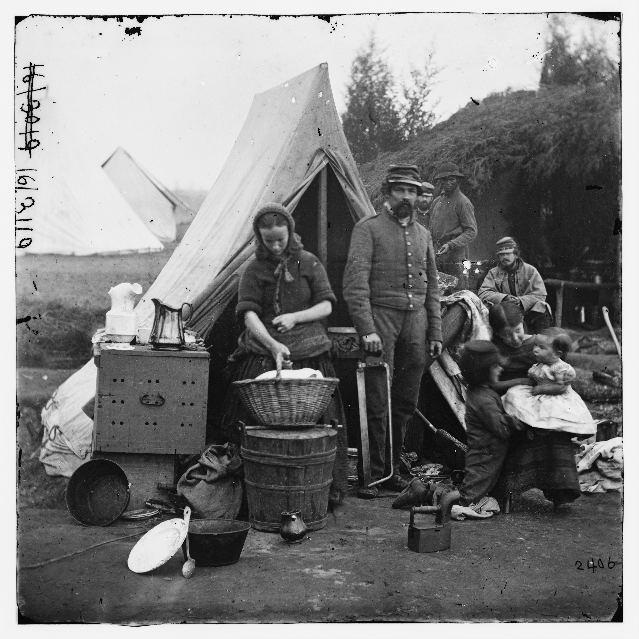 Image of Federal soldier and family (wife and three children) at their camp, Queen's Farm near Fort Bunker Hill during the Civil War.