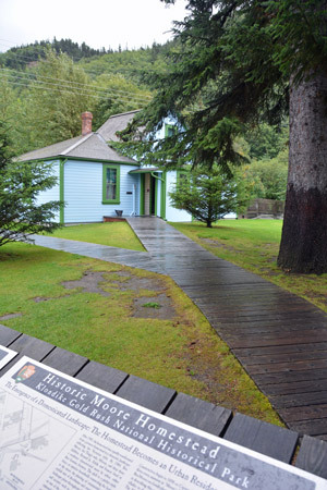 View from wayside of wooden boardwalk to park building.