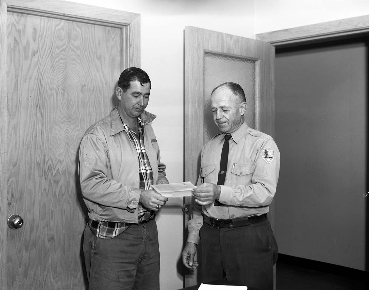 Superintendent Oberhansley presents three incentive awards to Roy O. Curbow.