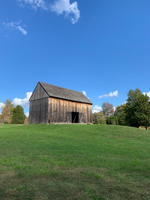 View of the Tobacco Barn looking from the bottom of the hill up to it. 