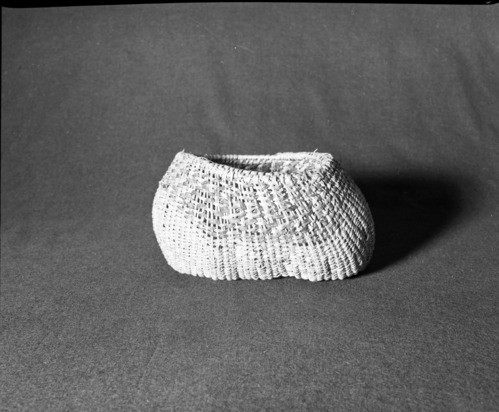Marie Rozier Collection, Catalog No. 77. Object: Miwok twined basket. Dimensions: 4-3/4 x 10 (diameter) x 7 (diameter). Materials: Split maple shoots, fern root, scraped shoots. Technology: Plain twined over paired warps; formerly had handle which has been broken off and is now missing. Collection History: Made for Mrs. Ida Hallen about 1915 by a local Native American woman. Gift of Florence Whitcomb. Photographed by Michael Dixon in December 1982. Catalogued by Craig Bates and Barbara Beroza. Yosemite Collections, National Park Service.