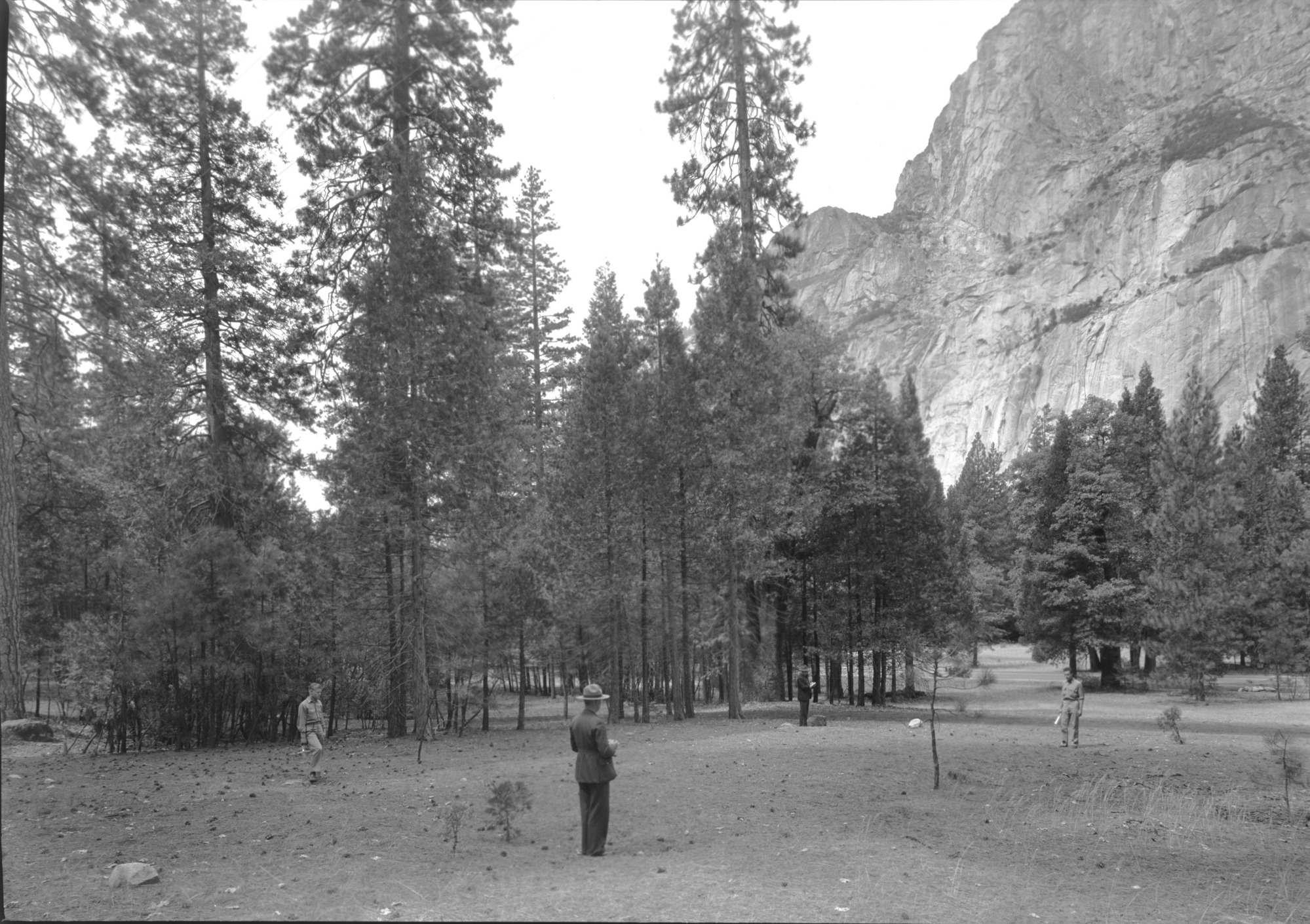 Men standing at corners of original site of first church in Yosemite Valley (Chapel later removed).