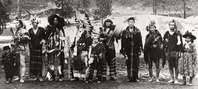 Black and white photograph of a line of American Indians standing for a photo