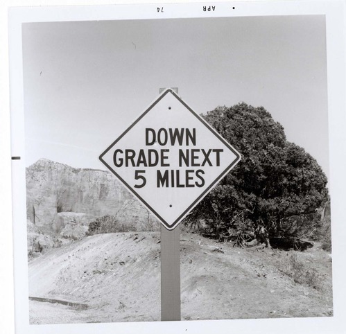 Road sign reading 'Down Grade Next 5 Miles' in Kolob Canyon.