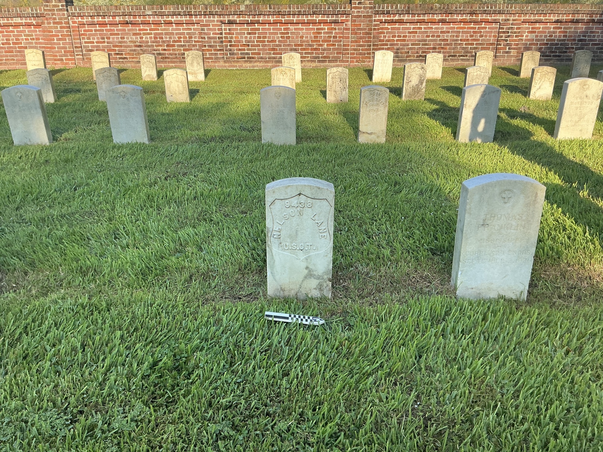 Extra image of historic upright marble headstone with recessed shield face.