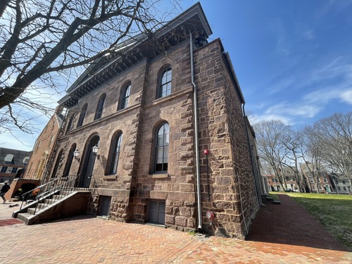 A two-story brown building. 