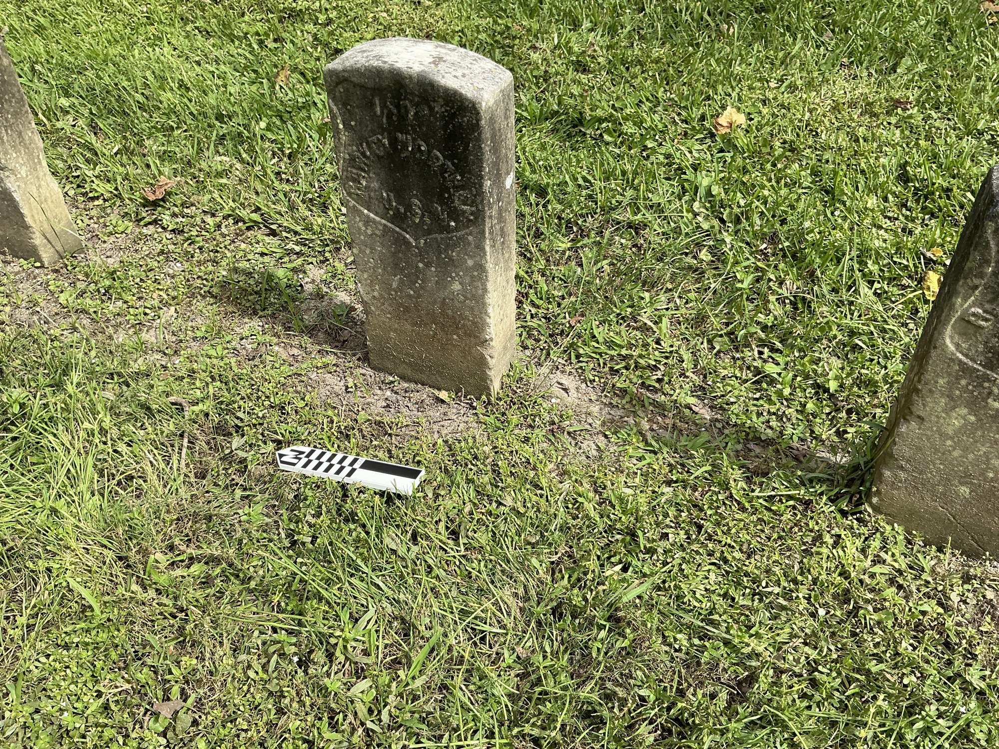 Extra image of historic upright marble headstone with recessed shield with recessed lettering face.
