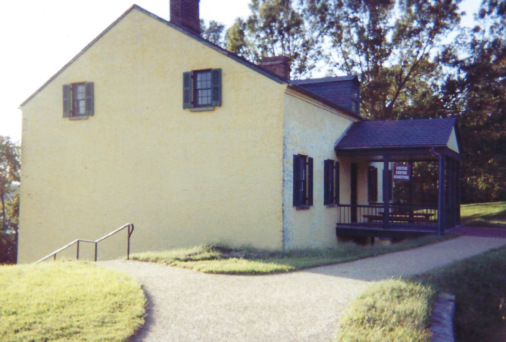 Photo of the Visitor Center north side with walkway to the porch
