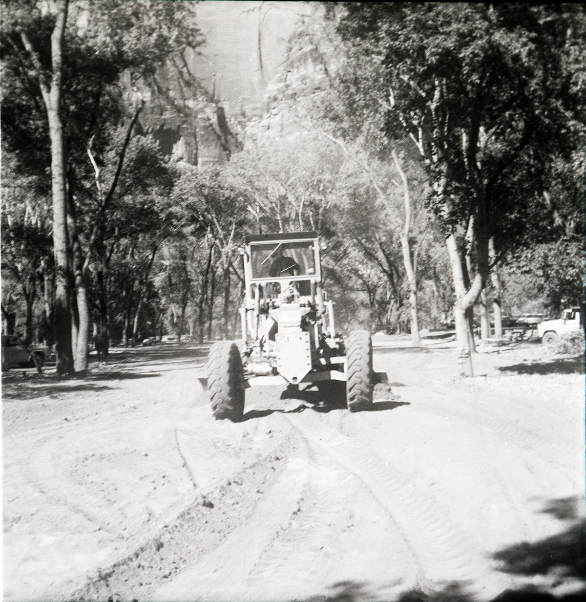 Tractor performing road work/construction for The Grotto parking area.