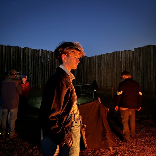 Union prisoner standing by the fire.