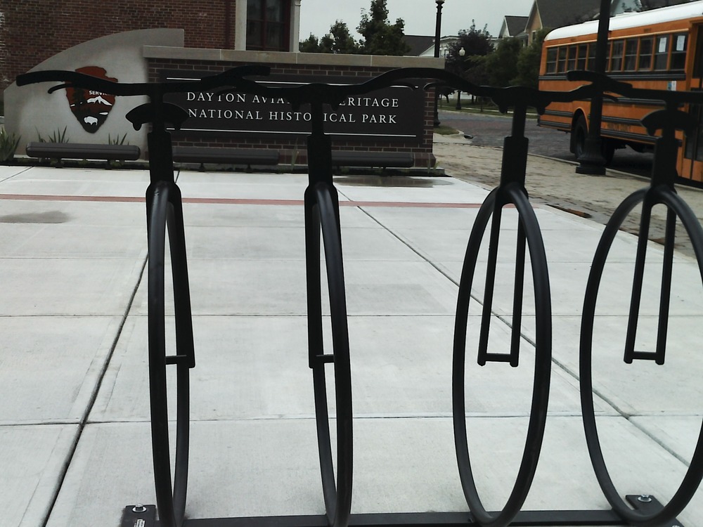 YMCA kids photograph bike stand on park plaza