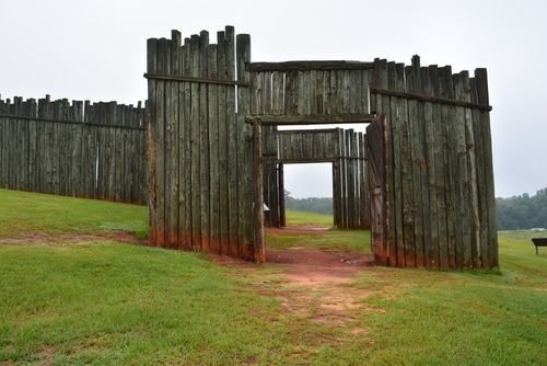 Wooden gates and walls on the side of a sloping hill.