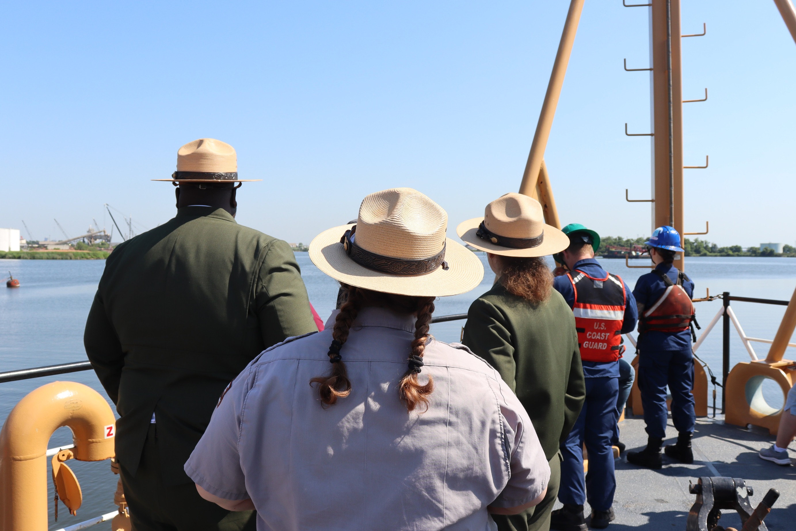 NPS rangers look out over Baltimore Harbor.