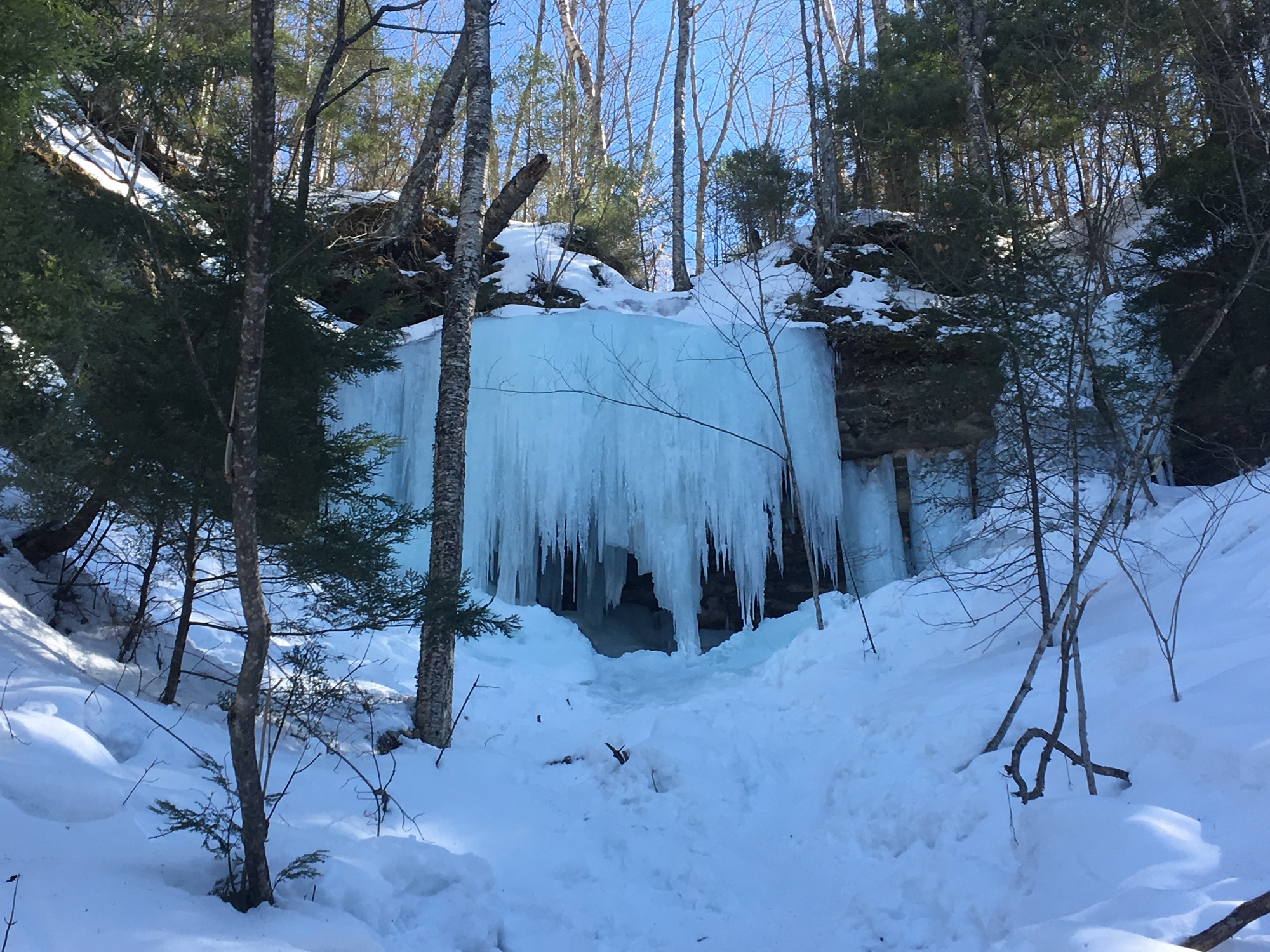 Ice Curtain called The Amphitheater hangs thick off the sandstone cliffs.