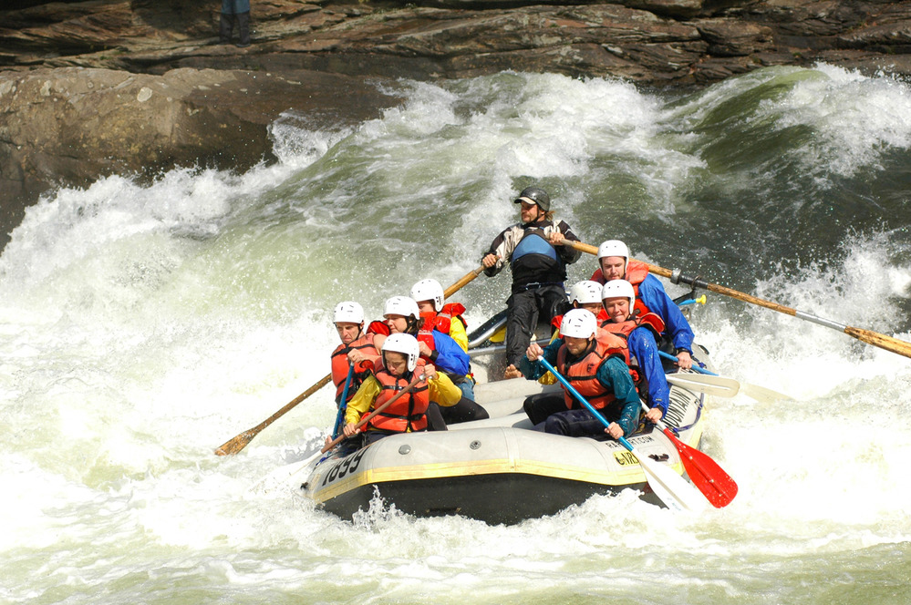 guide rowing through whitewater