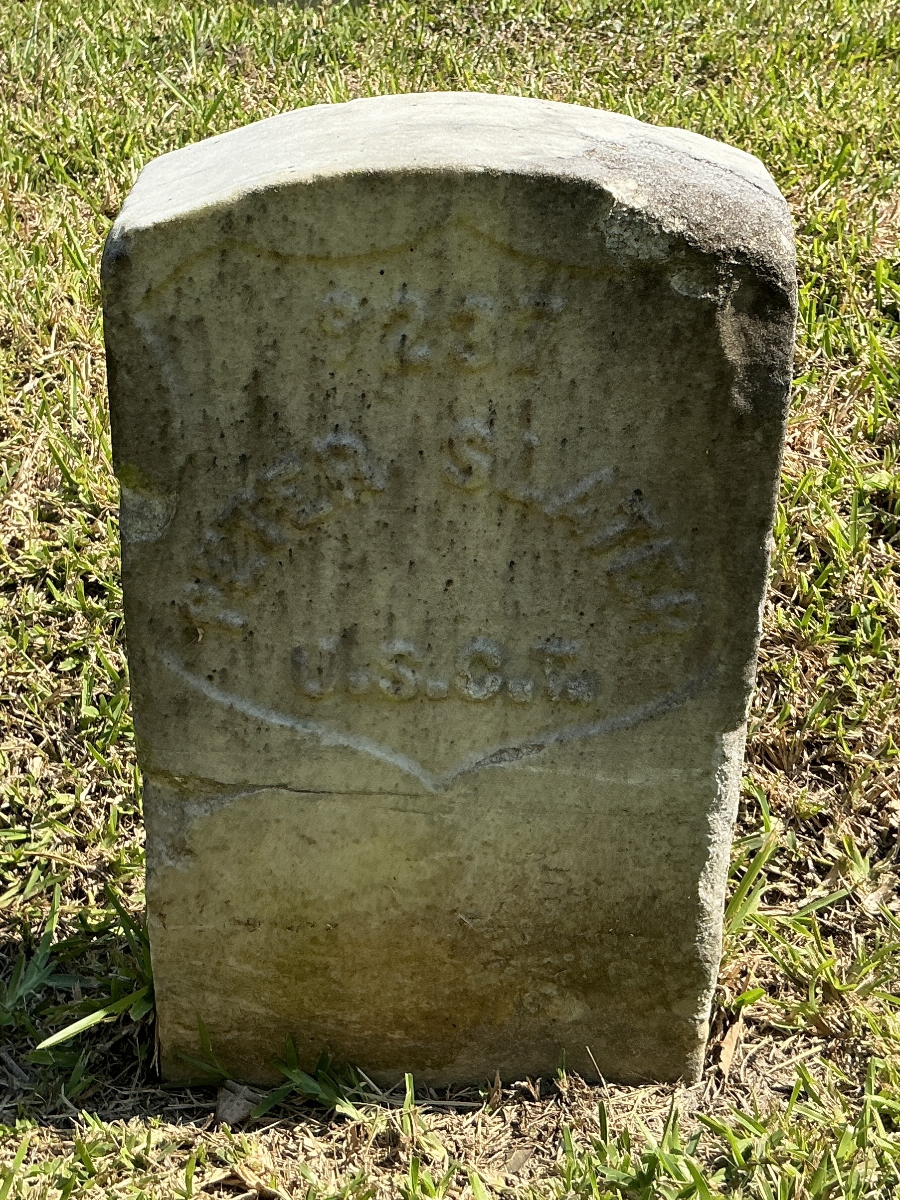 Front of historic upright marble headstone with recessed shield face.