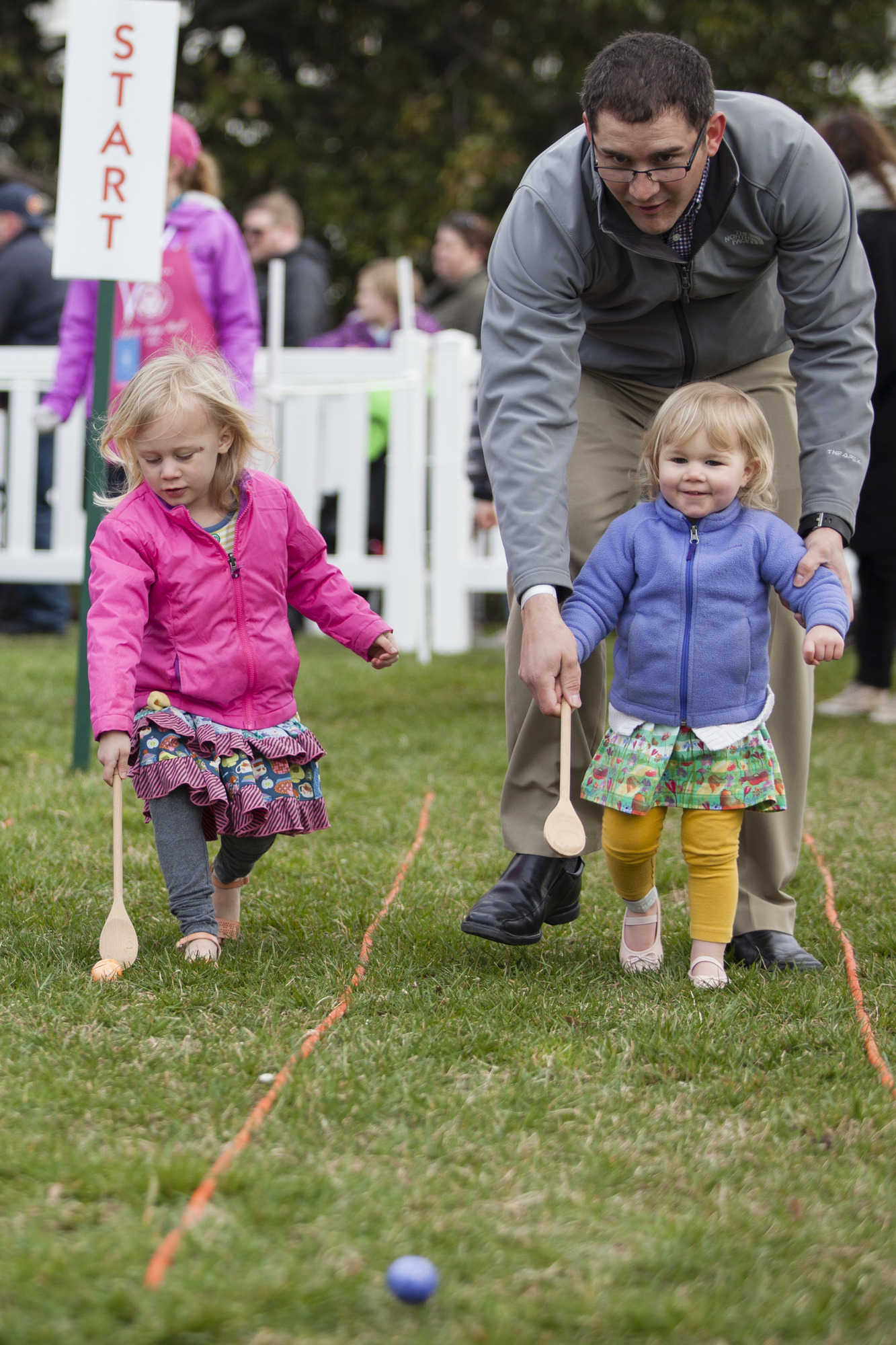 Two young children participate in the Egg Roll. 