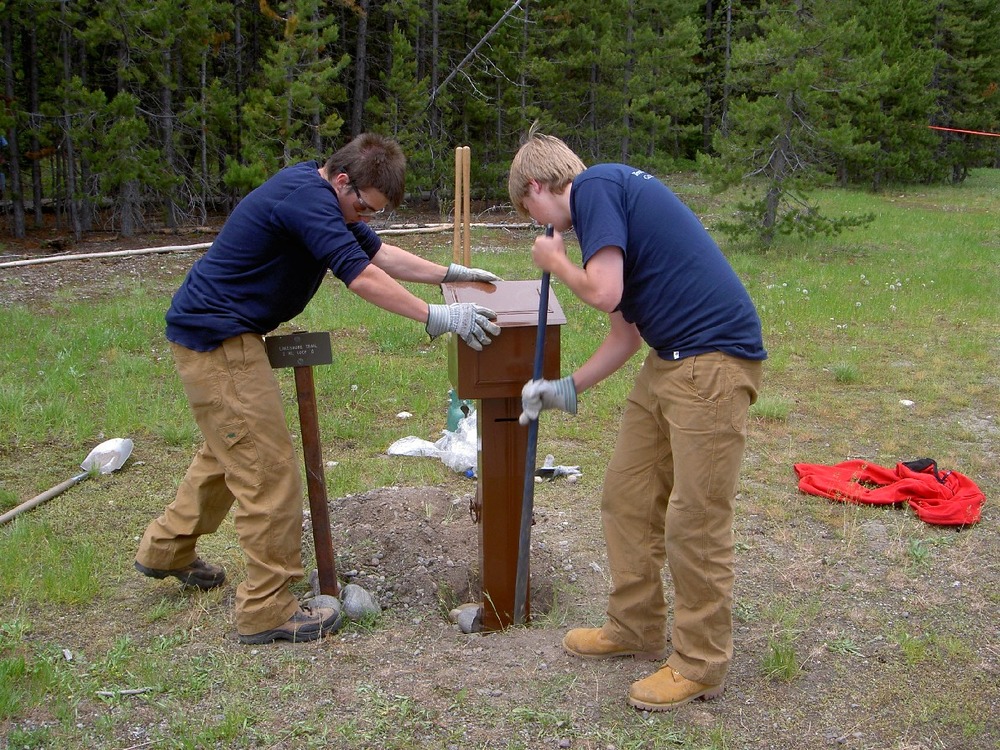 YCP workers installing trailhead brochure box.