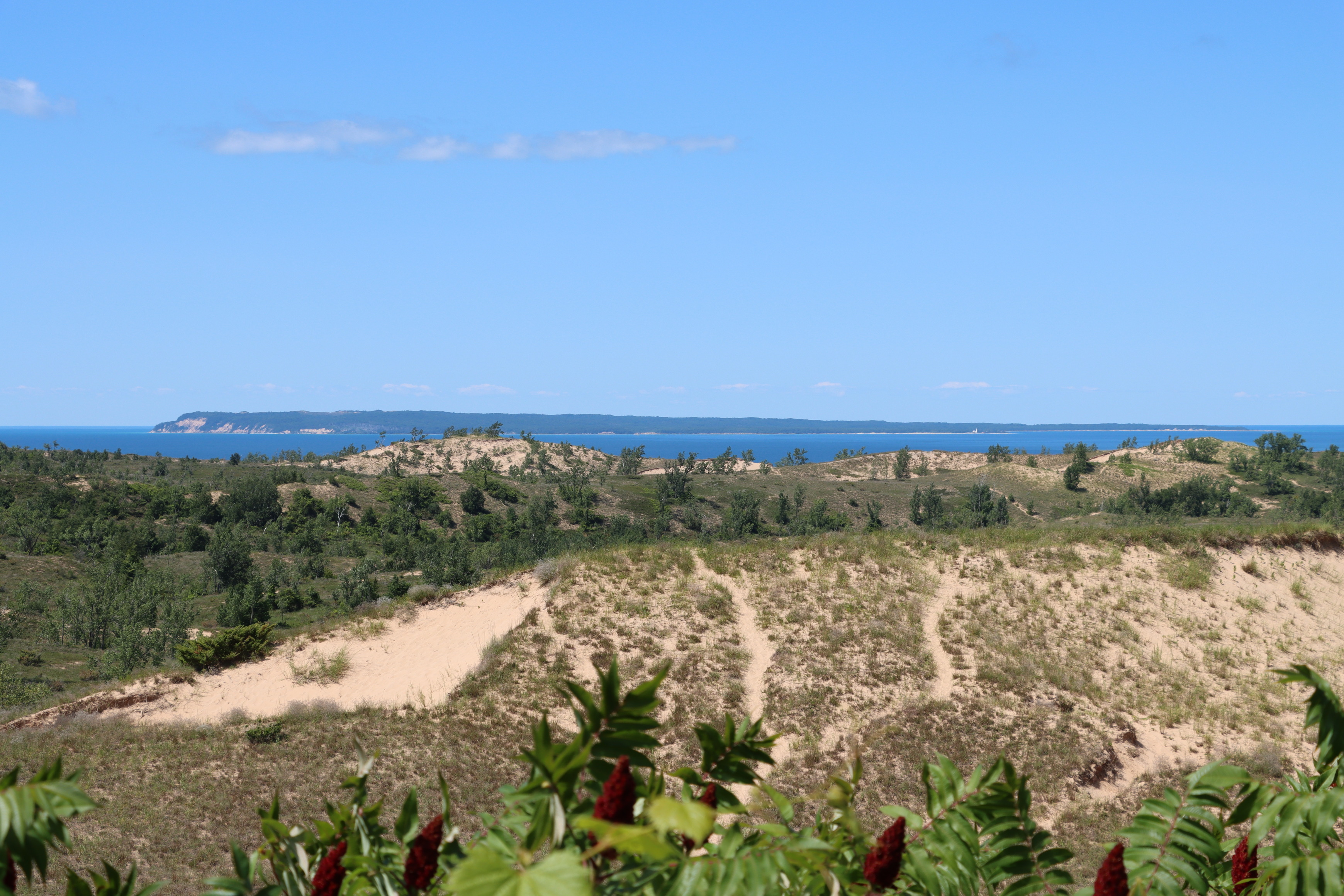 Catches your breath as you view rolling sand dunes followed by a blue Lake Michigan and South Manitou Island in the distance. 