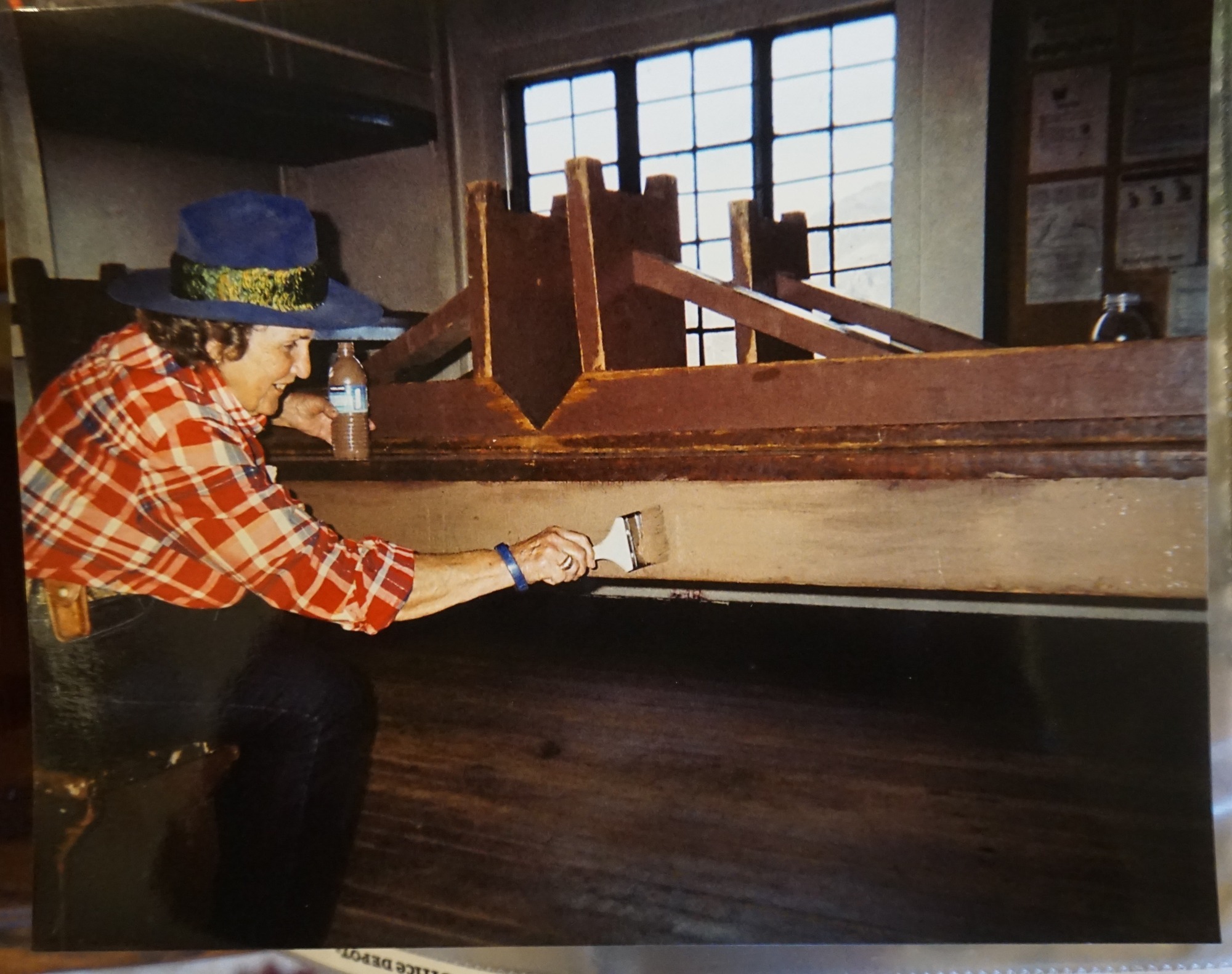 Rose Freitas painting the table in one of the visitor cabins