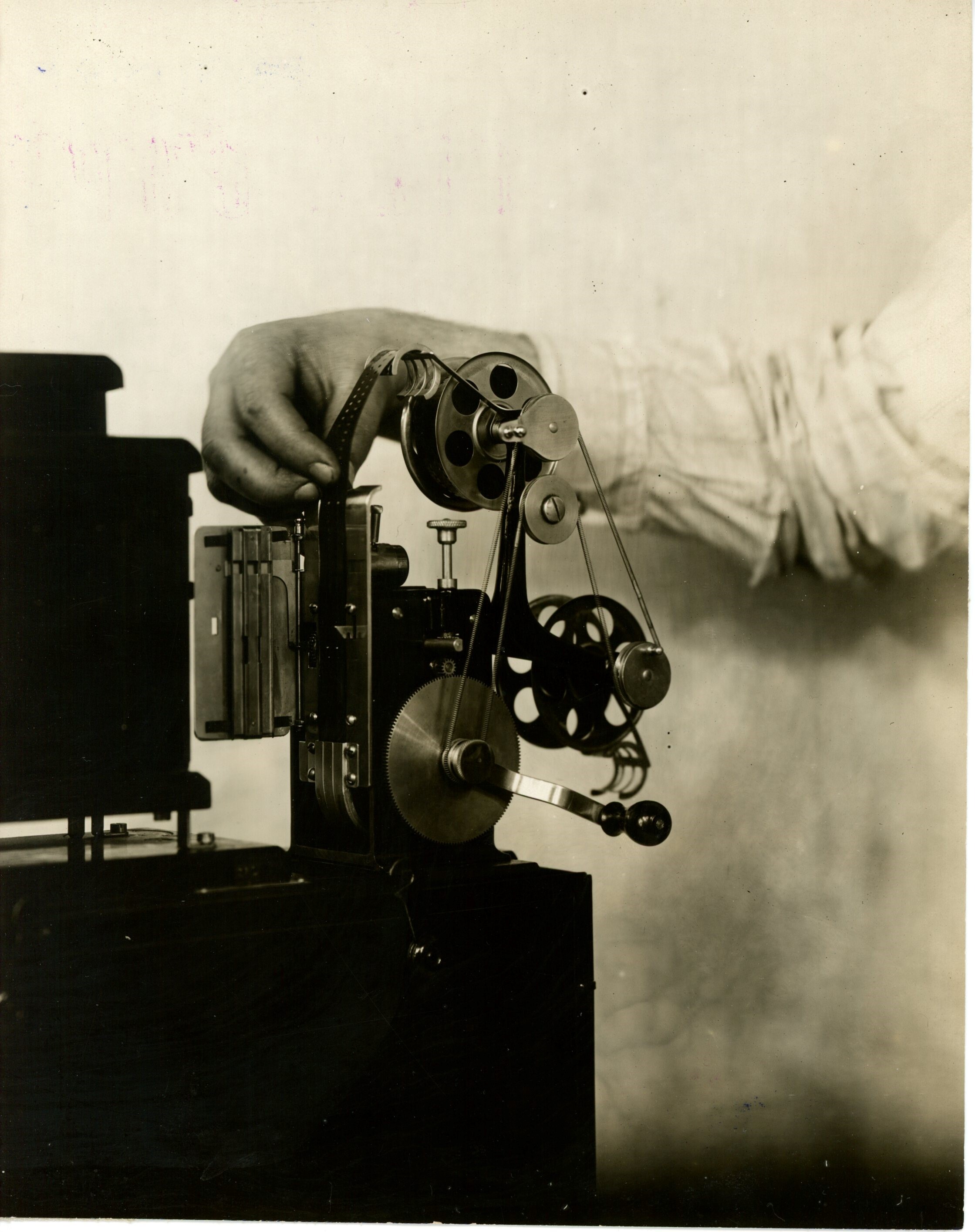 Edison home projecting kinetoscope, hands securing upper reel.
