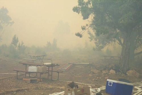 Burning and smoke in and around structures during the Long Mesa Fire, Mesa Verde National Park, July-August 2002
