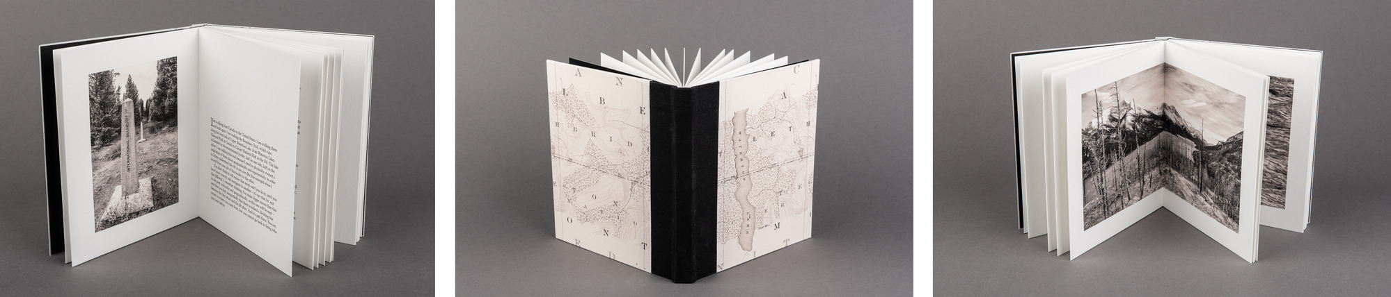 Three separate pictures of the "The Lines Across the Land, the Lines Across a Life" lined up next to each other. The picture on the left shows the book propped open with the pages facing the camera. The left page has a picture of a line of obelisks in the forest. The right page has writing on it. The middle picture shows the book propped open with the spin facing the camera. The cover of the book shows a map of the border between Montana and Canada. The right picture shows the book propped open with the pages facing the camera. A photo coving both pages of the open book shows snowy mountains and a lake in the background. A burnt forest is in the foreground.
