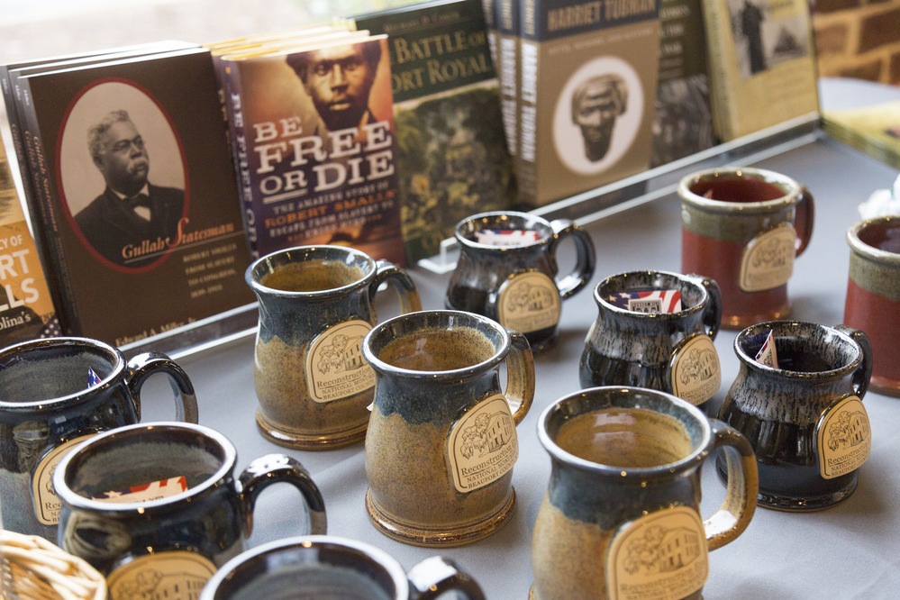Clay coffee mugs set out on display for sale. 