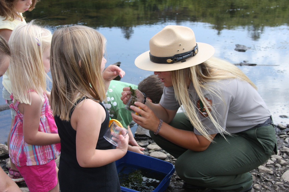 A Park Ranger interacting with children.