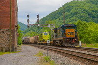 train alongside brick buildings