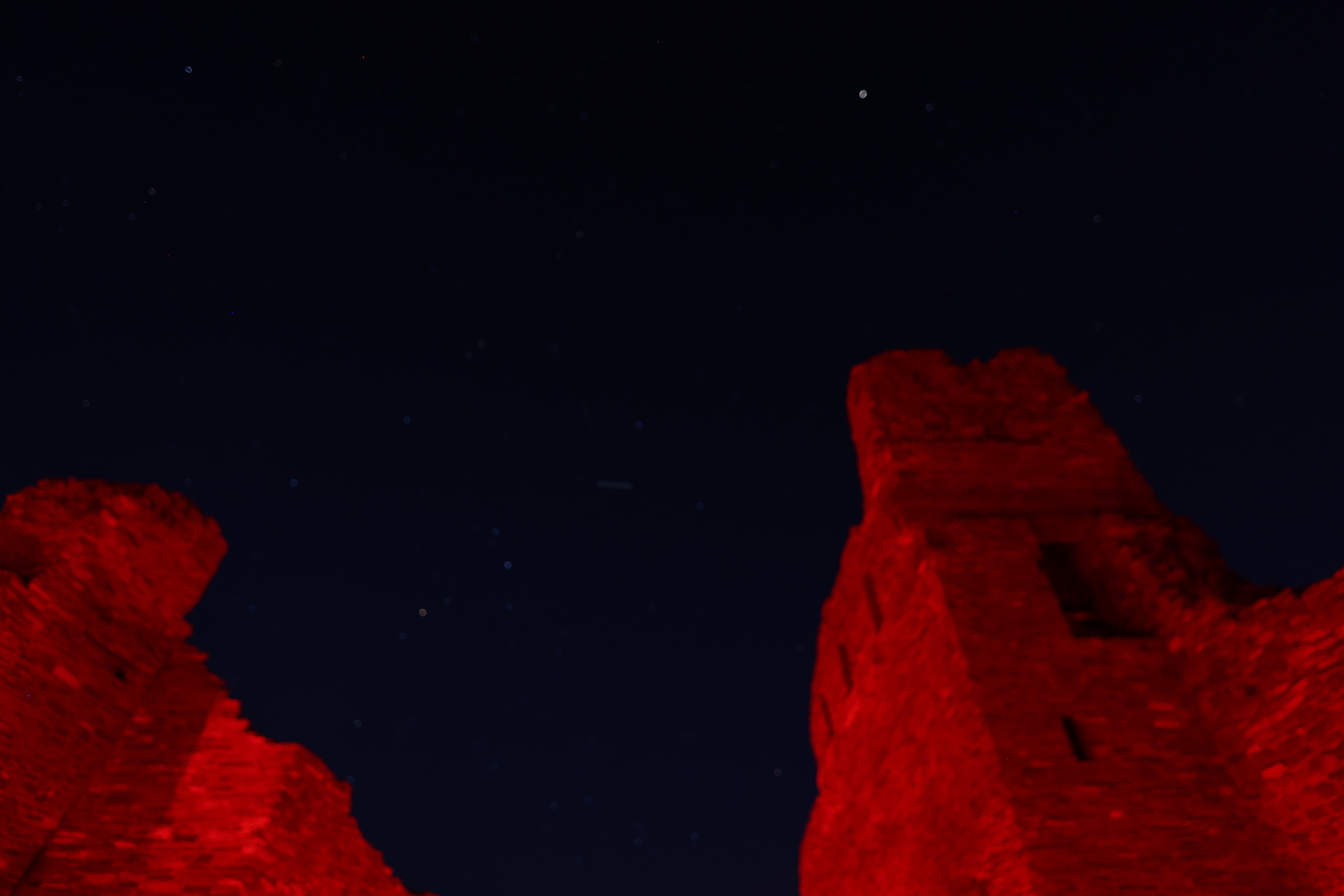 Dark sky image with church remnants in the foreground.