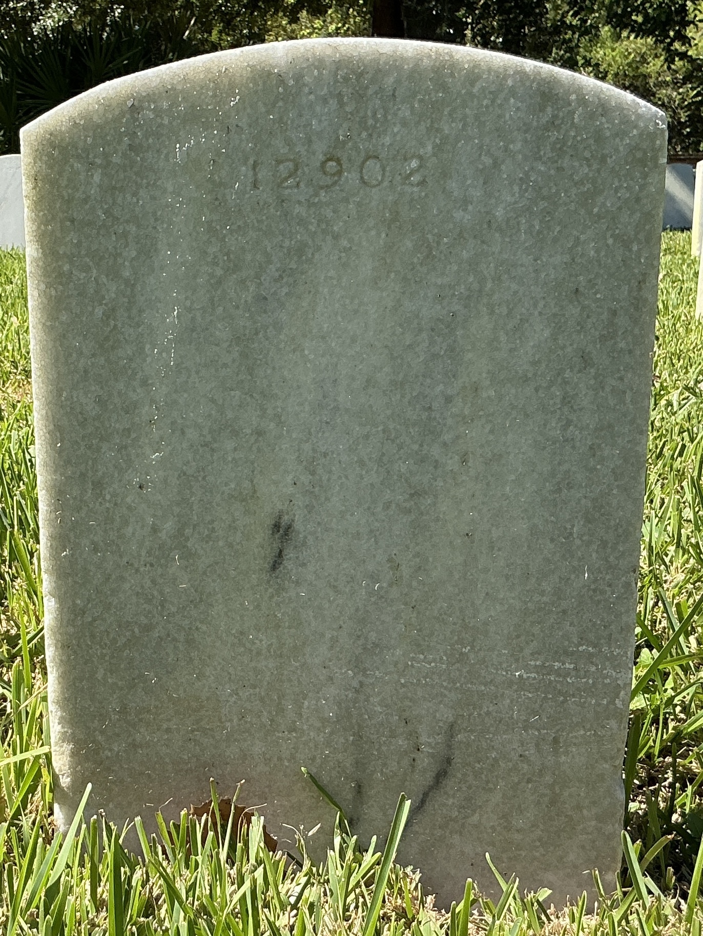 Back of upright marble headstone with flat face.