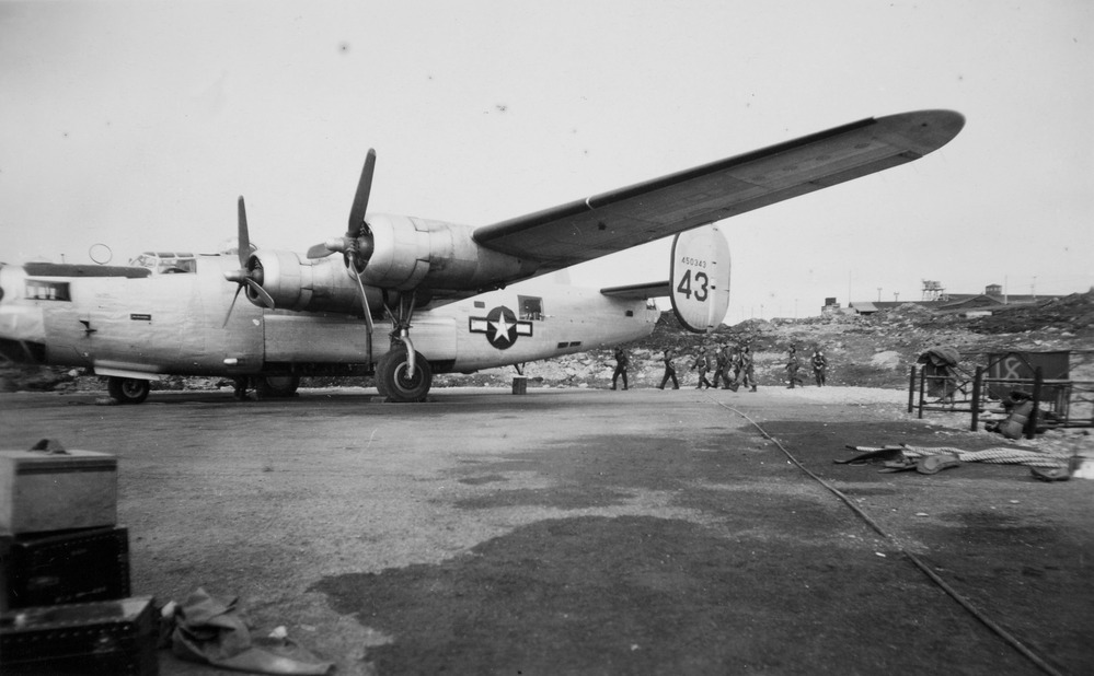 airmen standing by plane 