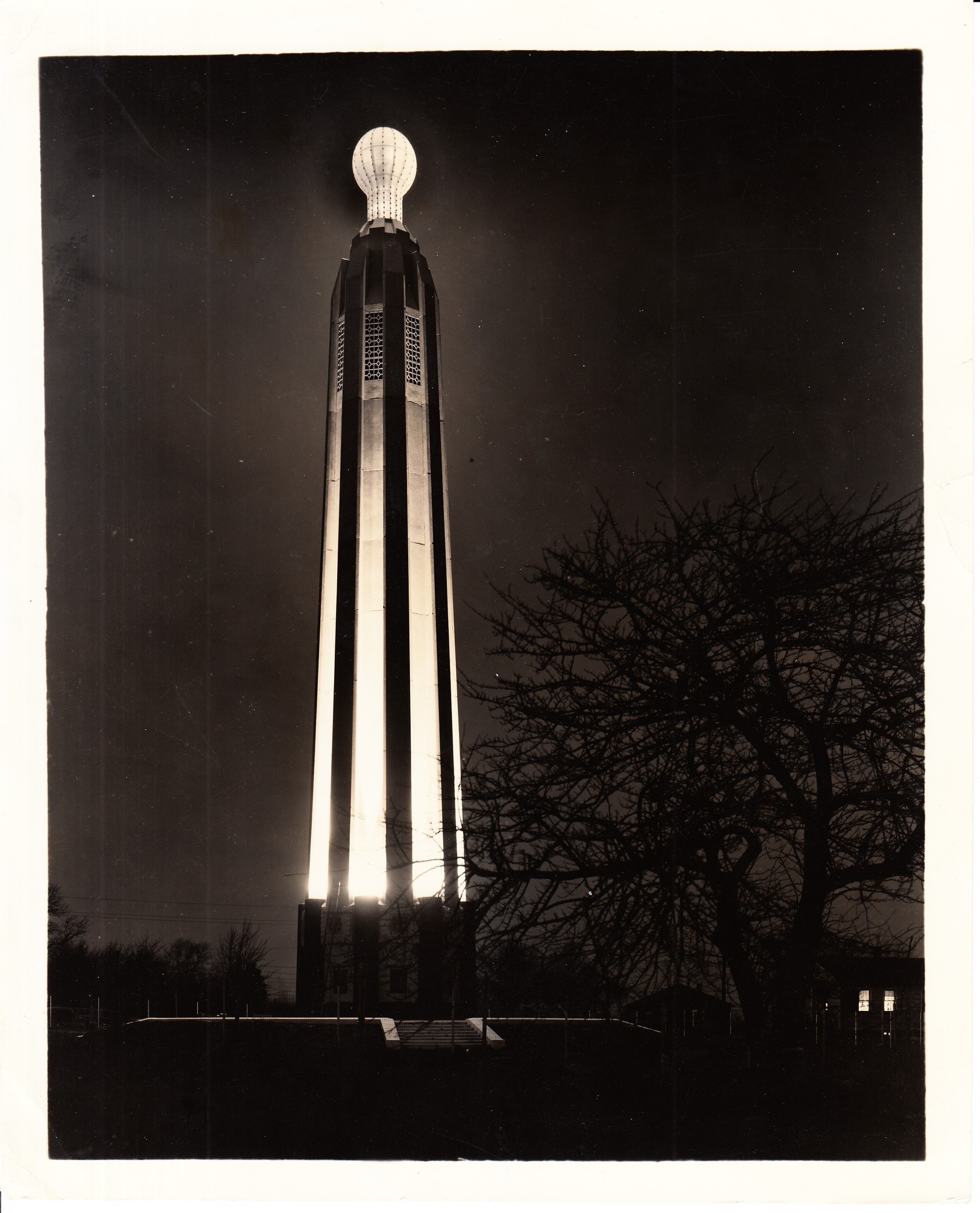 Edison Tower, Menlo Park, New Jersey, with model of incandescent lamp illuminated.