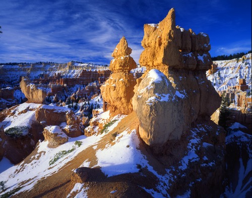 a strange looking hoodoo with snow