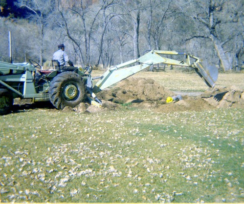 Man operating excavator during the Zion Lodge utilities project.
