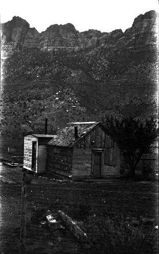 Pioneer dwellings near Springdale, wood cabin. cabin probably built by Moses Gifford around 1880. Located just south of school house in Springdale. Notation: This building was the home of Elias Gifford, son of Moses, for a few years in the late 1920s, before he moved to Draper, Utah. Probably built around 1925.