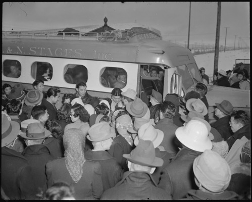 A large group of friends wish bon voyage to a group of eleven evacuees, who are leaving the center. Of this group, seven were students and workers going out on indefinite leave, and the other four were transfers to the Central Utah Project. Mixed emotions were displayed as these people boarded the bus