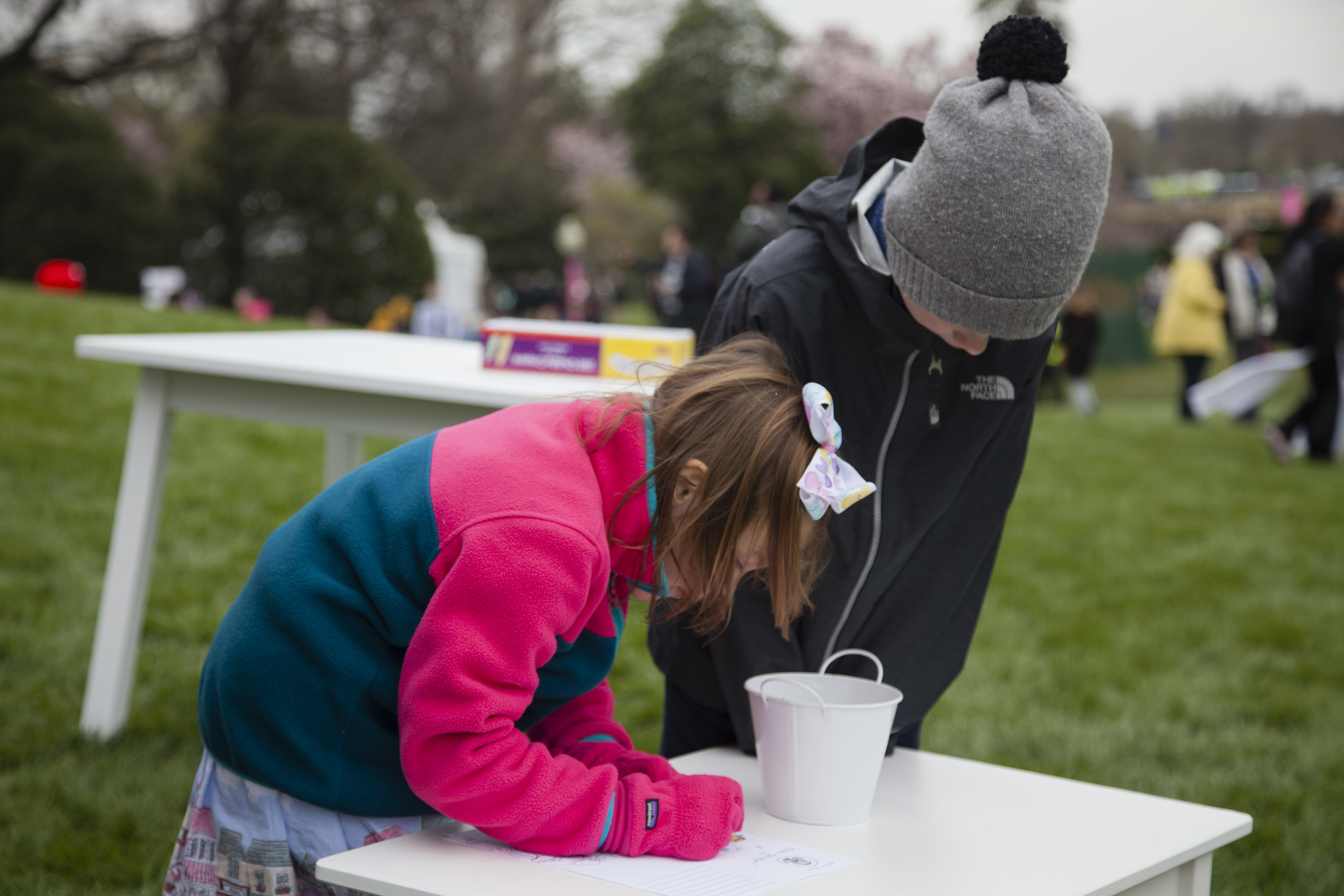 Children color activity sheets at the 2017 Easter Egg Roll. 