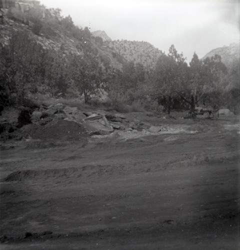 Dirt road with rock piles along the scenic canyon drive near the Grotto during construction.
