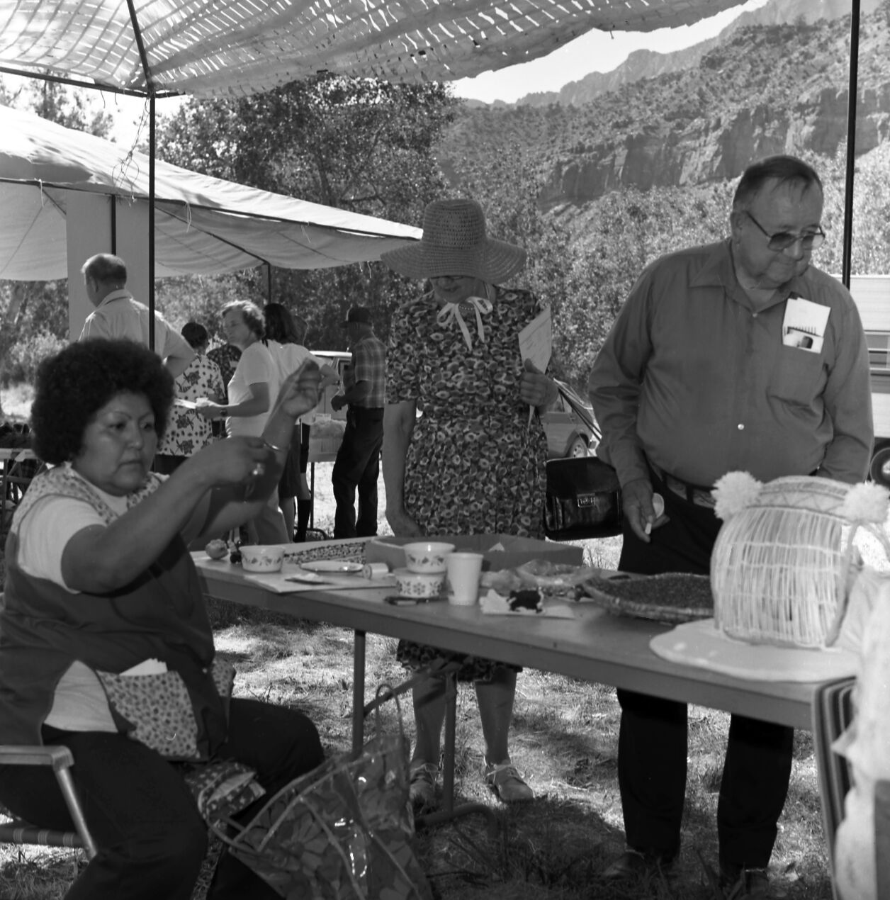 Paiute woman demonstrating woven cradle boards for visitors at the third Folklife Festival at the Zion National Park Nature Center, September 1979.