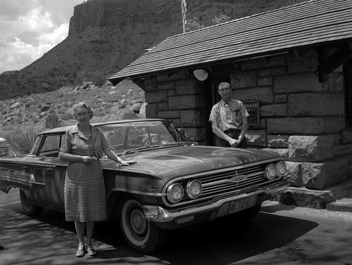 Ernest and Stella Gisseman of Midvale, Utah, pose next to their vehicle at the park entrance station. The Gissemans are the Millionth Visitor to Zion National Park.